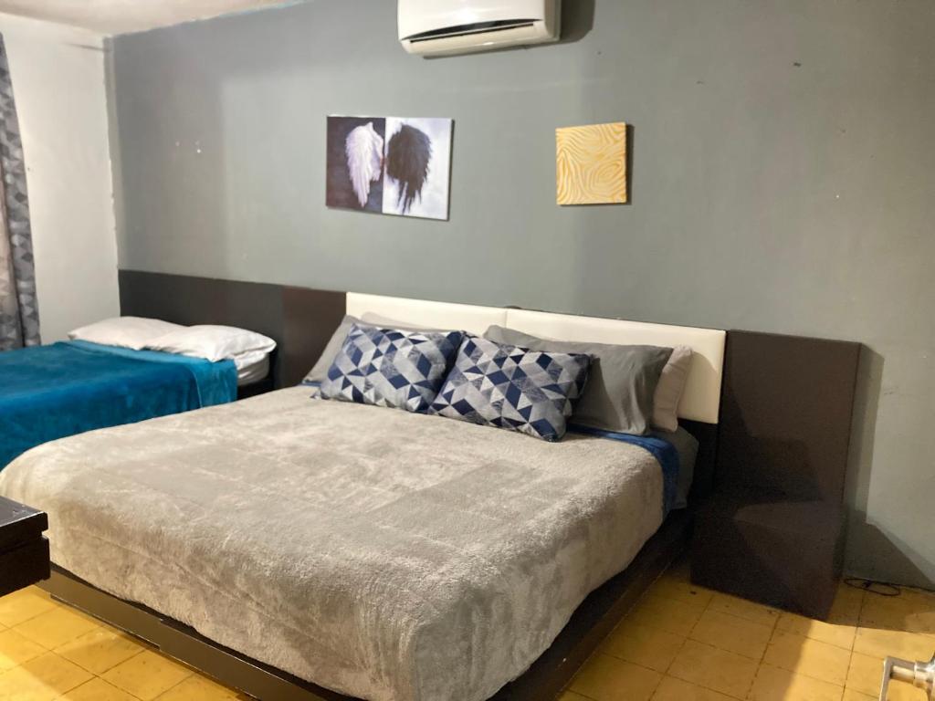 a bedroom with a bed and two pictures on the wall at Apartamento con cochera centro de la ciudad. in La Paz