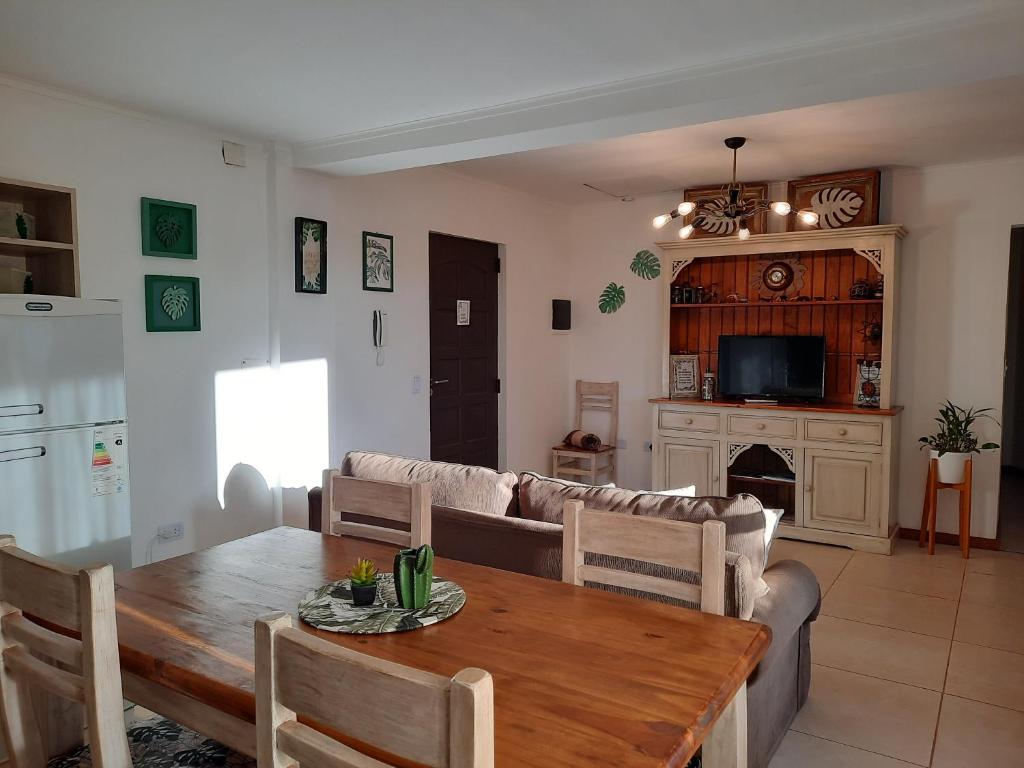 a living room with a table and a couch at Las Arecas - 3° B in Puerto Iguazú