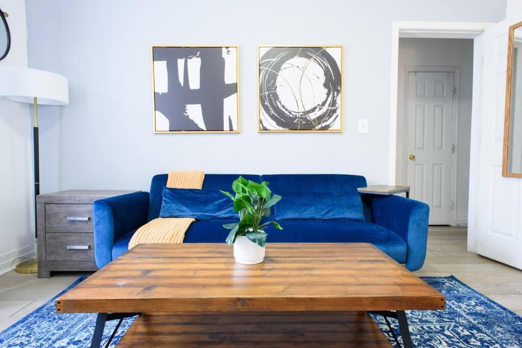 a living room with a blue couch and a table at 428-2W Newly Furnished Prime Location 2BR Sleeps 5 in New York