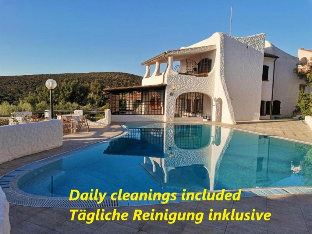 una casa con piscina frente a ella en Sant'Antioco island Sea View an Exclusive Villa by the Sea with extra Privacy & Care en Maladroscia