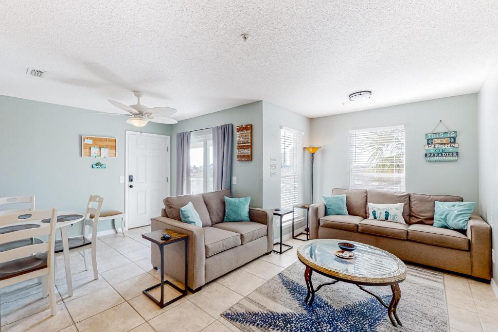 a living room with two couches and a table at Gulf Island 412 in Navarre