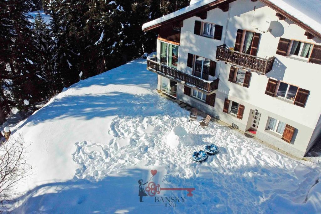a house with a lot of snow in front of it at Chalet 5 stars in San Bernardino, SKI SLOPES AND HIKING, Fireplace, 4 Snowtubes Free, Wi-Fi Free, for 8 persons, Wonderful in all seasons -By EasyLife Swiss in San Bernardino