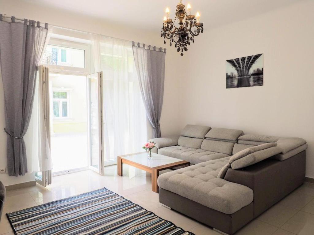 sala de estar con sofá y mesa en City Villa Schönbrunn Apartments - Contactless 24h Check-In, en Viena