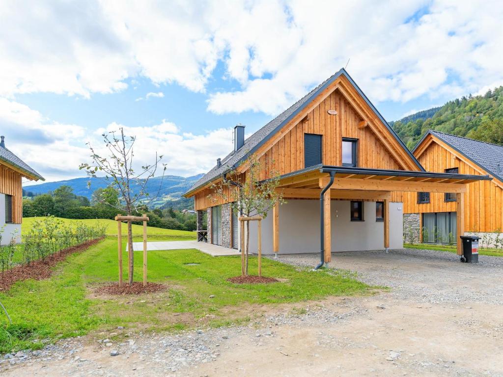a wooden house with two trees in front of it at Mountain Vista in Sankt Lorenzen ob Murau