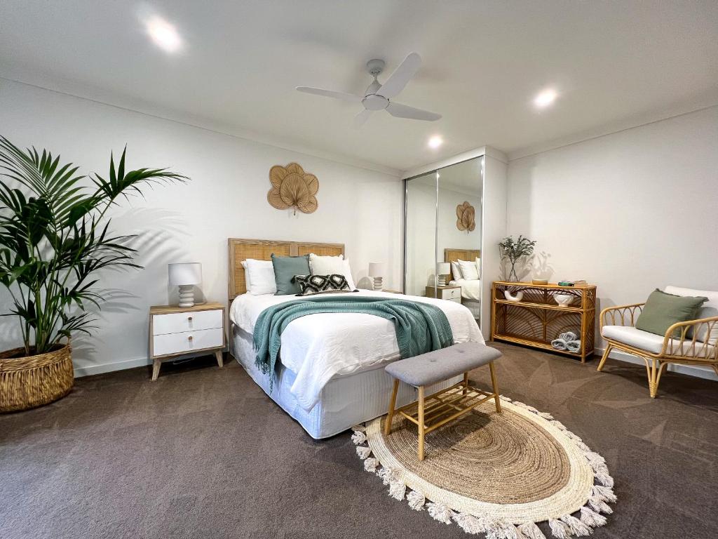 a bedroom with a bed and a chair and a mirror at Hahndorf Creek Retreat in Hahndorf