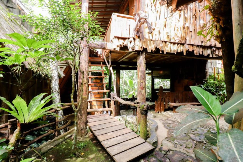 a log cabin with a staircase leading up to it at Rimbono Homestay in Borobudur