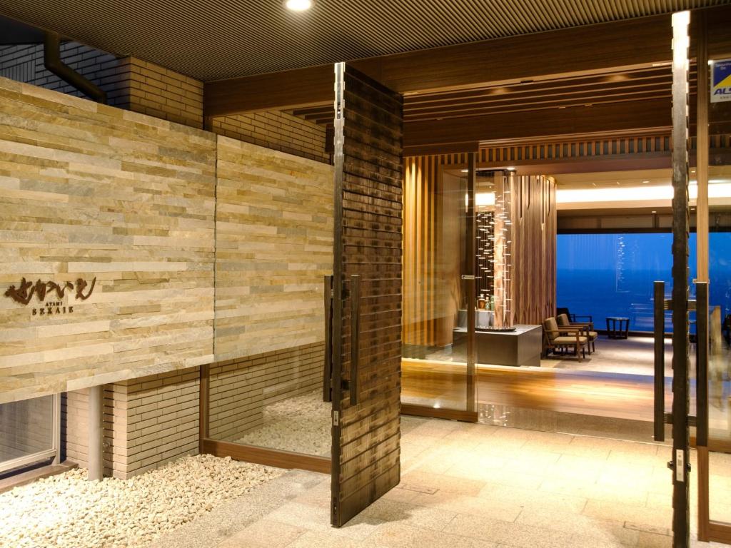 a lobby of a hotel with a view of the ocean at Atami Sekaie in Atami