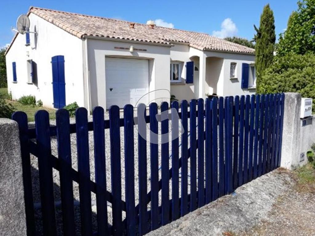 a blue fence in front of a white house at Maison Angles , 4 pièces, 4 personnes - FR-1-357-6 in Angles