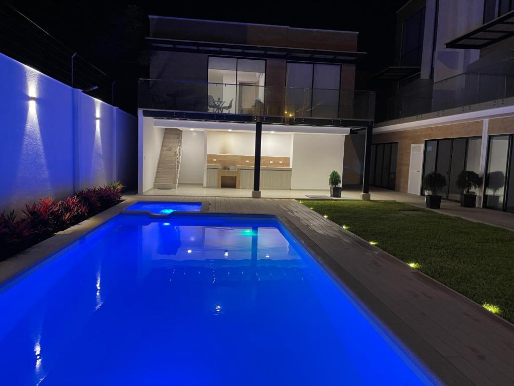 a swimming pool in front of a house at night at Suite Nueva Salinas-Chipipe in Salinas