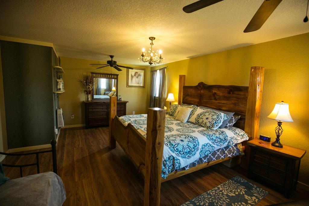 a bedroom with a bed with a blue and white comforter at Climb On Inn - Red River Gorge Kentucky - Amazing Home ! 