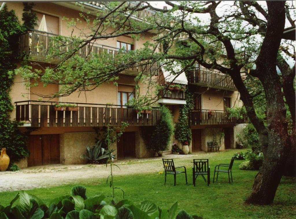 a large building with chairs in the yard at B&B Alle Querce in San Giovanni Rotondo