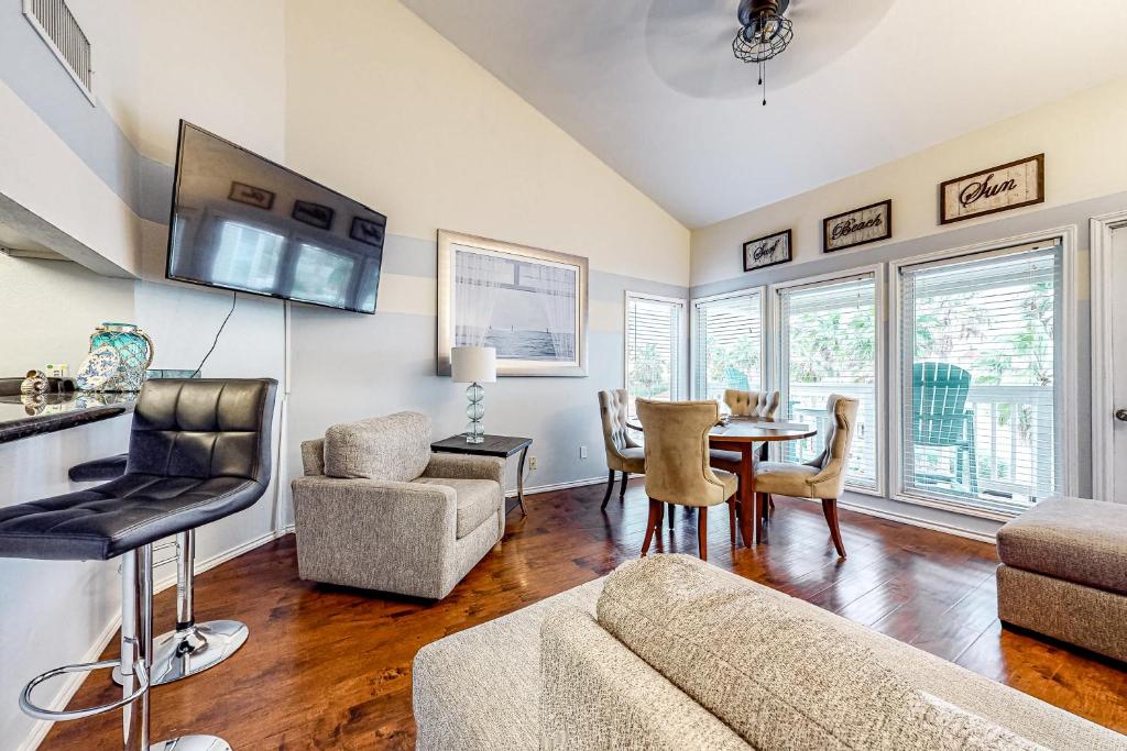 a living room with a couch and a table and chairs at Gulf Point Condominiums #1314 in South Padre Island