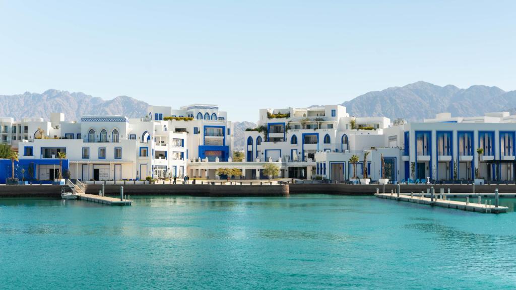 a group of buildings next to a body of water at Cloud 7 Residences Ayla Aqaba in Aqaba
