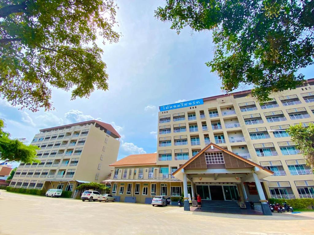 ein großes Hotel mit zwei Gebäuden auf einem Parkplatz in der Unterkunft Maihom Resort Hotel in Nakhon Sawan