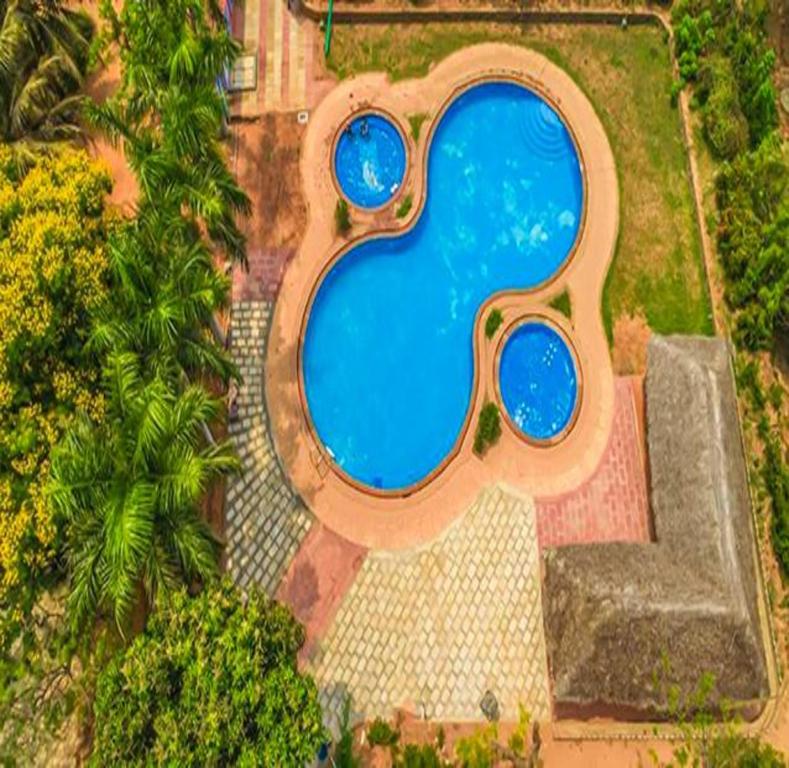 an overhead view of a swimming pool in a yard at FabEscape Queens Paradise in Pondicherry