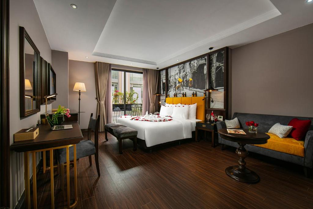 a hotel room with a bed and a couch at Hanoi Lion Boutique Hotel in Hanoi