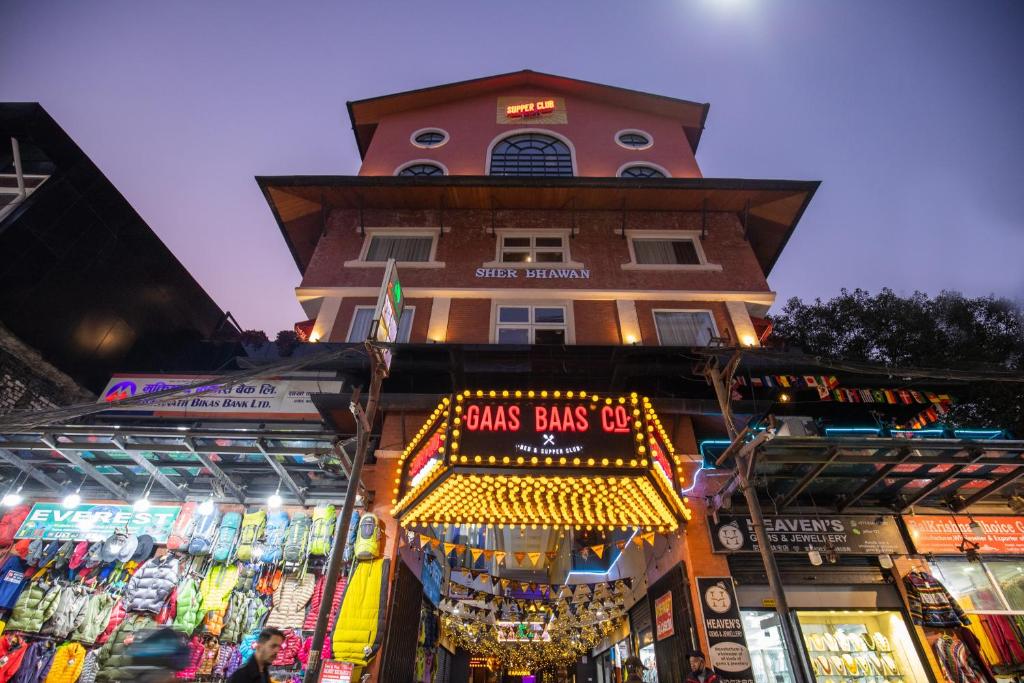 a building with a sign that reads guns balls go at Gaas BaasCo in Kathmandu