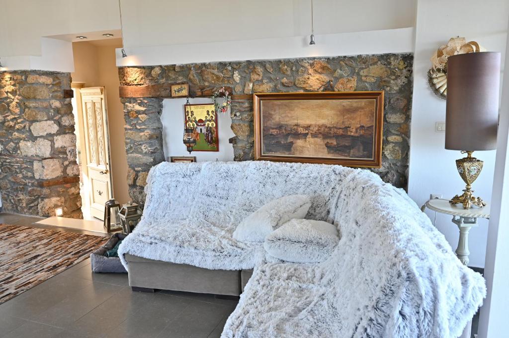 a bedroom with a bed and a stone wall at Fairytale house 