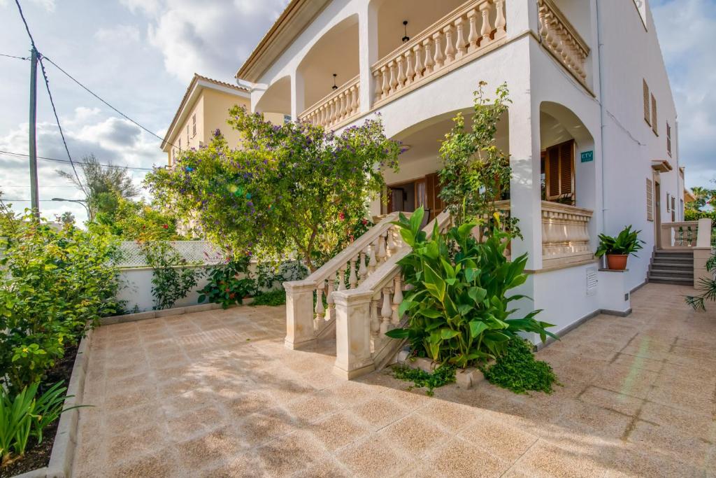 a villa with a staircase in a courtyard at Ideal Property Mallorca - Tobalu in Colonia Sant Jordi