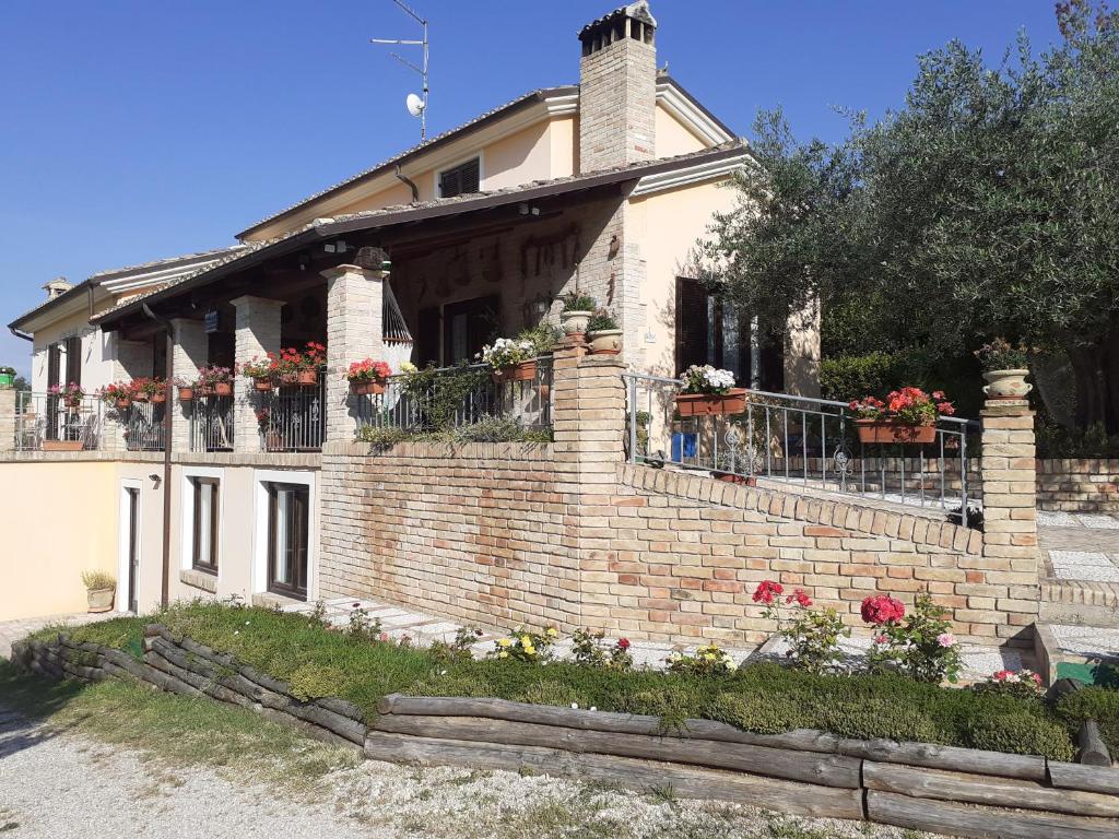a brick house with flower boxes on the balcony at VILLETTA TRA GLI ULIVI in Citta' Sant'Angelo