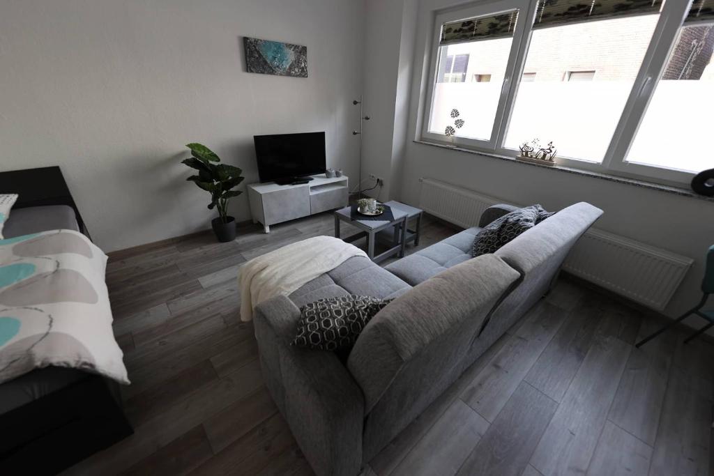 uma sala de estar com um sofá e uma televisão em Zufluchtshütte em Herzogenrath