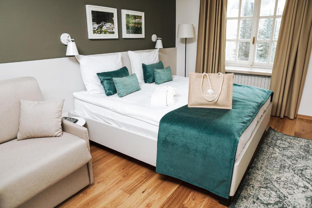 a hotel room with a bed with a purse on it at Depandance Vila Higiea - Terme Dobrna in Dobrna