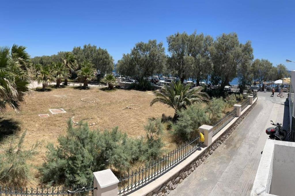 a view of a park with trees and a field at Beach apartment Edem first floor in Perivolos