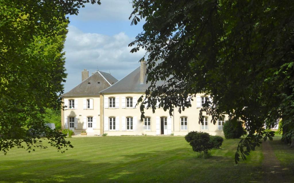 uma grande casa branca com um grande quintal em Maison d'hôtes Le Château de Puxe em Puxe