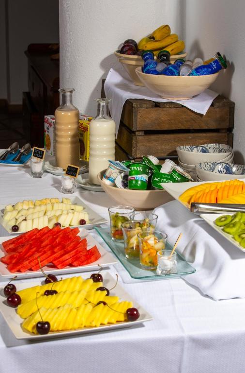 a white table with plates of food on it at Boutique Hotel El Tio Kiko in Agua Amarga