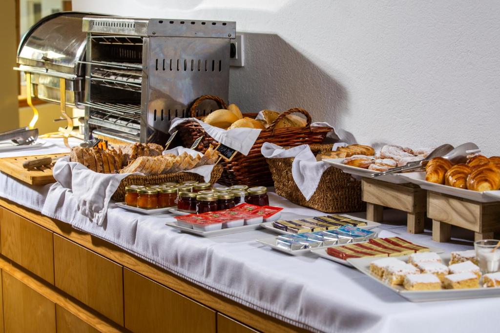 a buffet with bread and pastries on a table at Boutique Hotel El Tio Kiko in Agua Amarga
