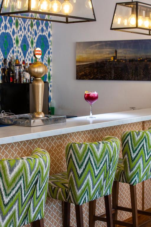 a bar with two green and white bar stools at Boutique Hotel El Tio Kiko in Agua Amarga