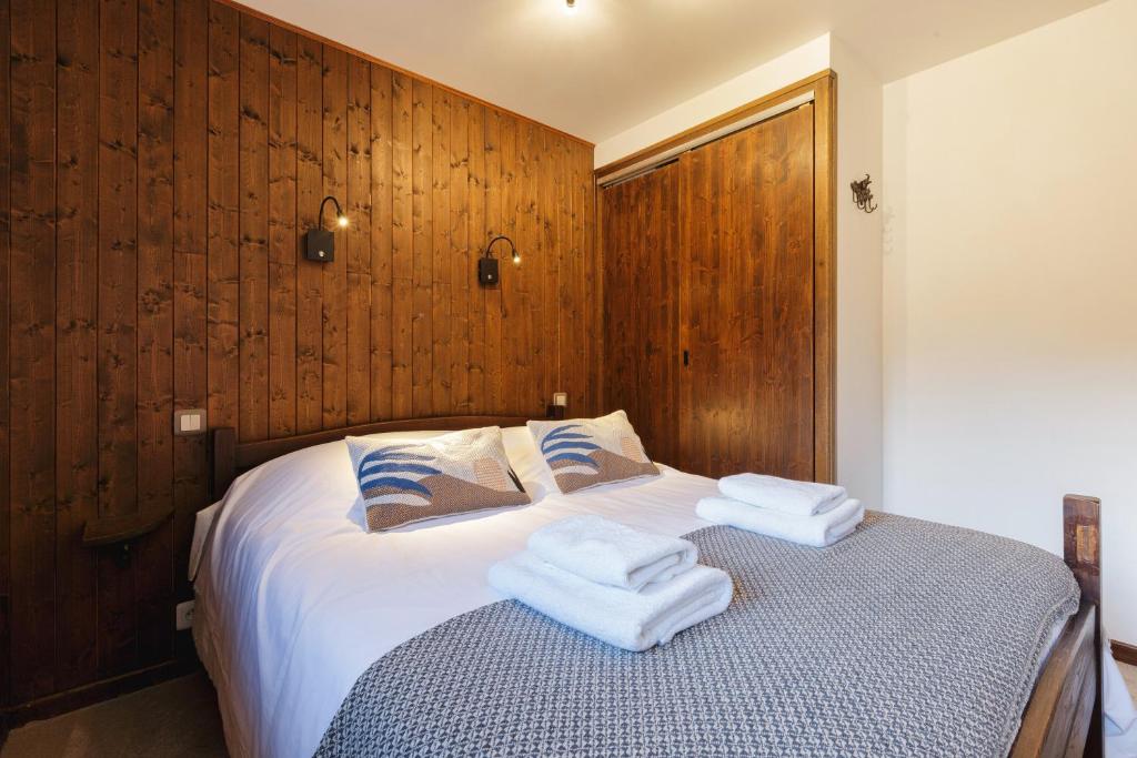 a bedroom with a bed with towels on it at La Maison De Montroc - Happy Rentals in Chamonix