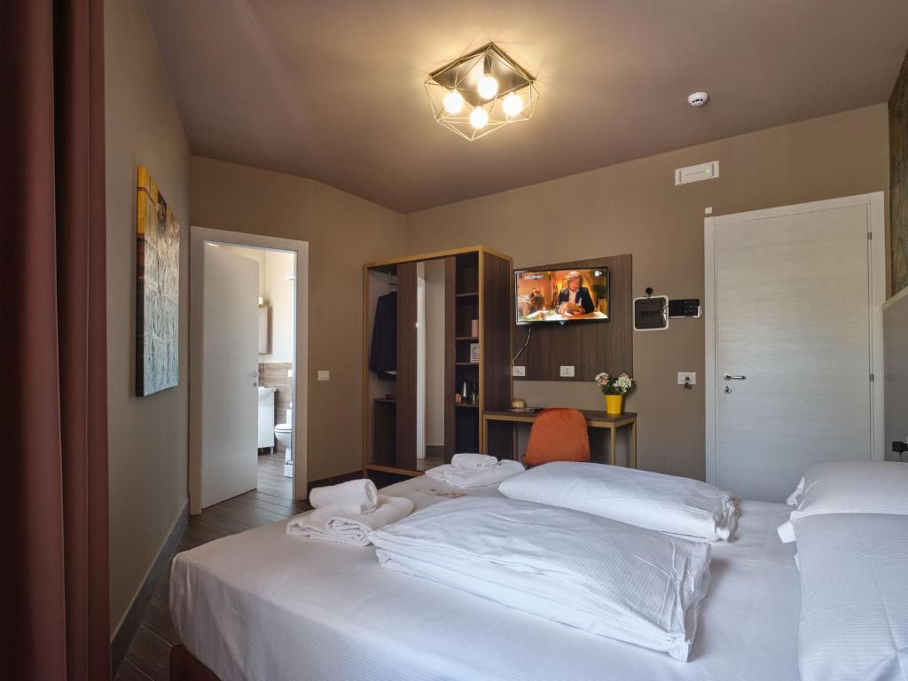 Postel nebo postele na pokoji v ubytování Hotel Giulietta