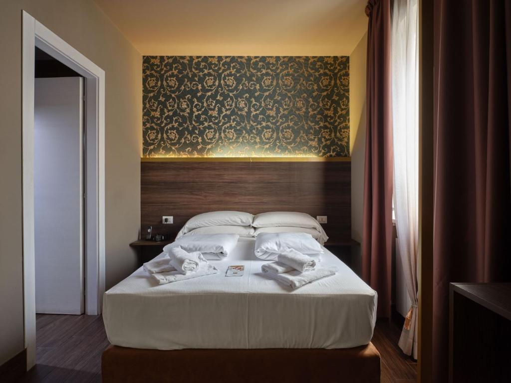 Postel nebo postele na pokoji v ubytování Hotel Giulietta