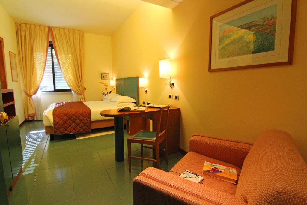 a hotel room with a bed and a couch at Hotel Cristallo in Giulianova
