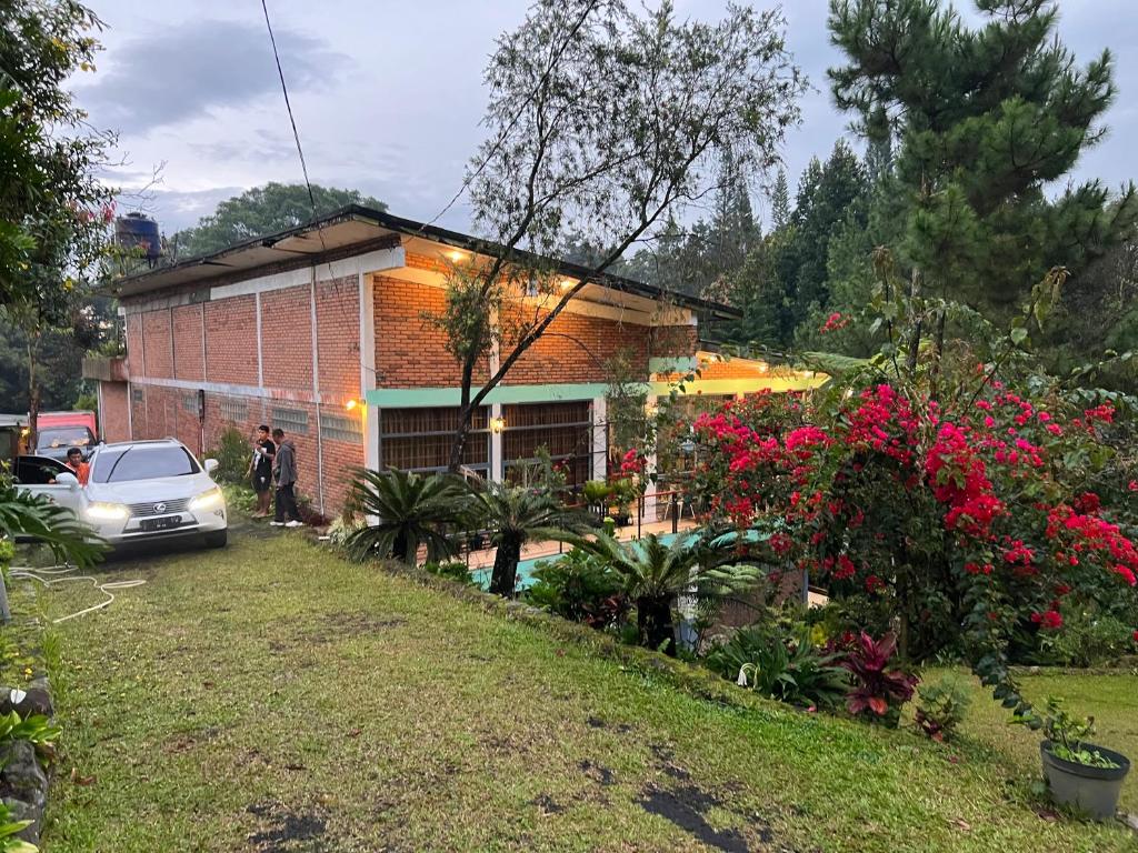 a house with a car parked in front of it at Villa Bokiko in Puncak