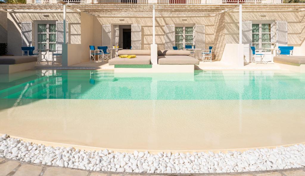a swimming pool with blue and white water at Hydrele Beach Hotel & Village in Potokáki