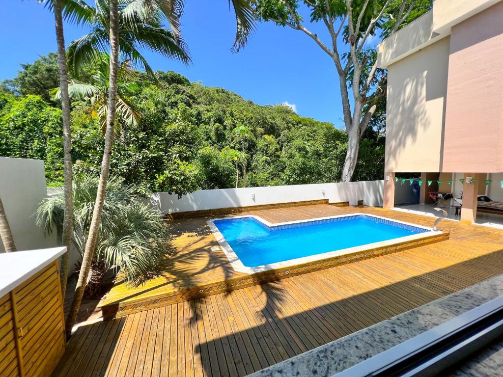 a swimming pool on the deck of a house at Pousada Altas Natureza in Florianópolis