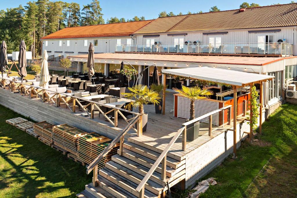 a restaurant with tables and chairs on a deck at Best Western Hotell Hedåsen in Sandviken