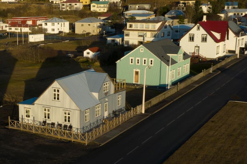 an aerial view of a town with houses and a road at Pálshús in Patreksfjörður