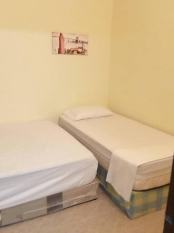 Postel nebo postele na pokoji v ubytování RAS Hotel