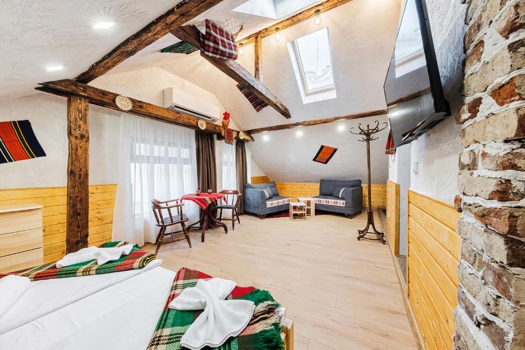 a room with two beds and a living room at Sofia Folklore Life Apartment in Sofia