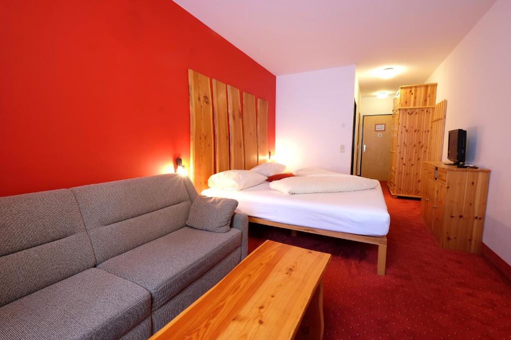 Postel nebo postele na pokoji v ubytování Alpenhotel Marcius