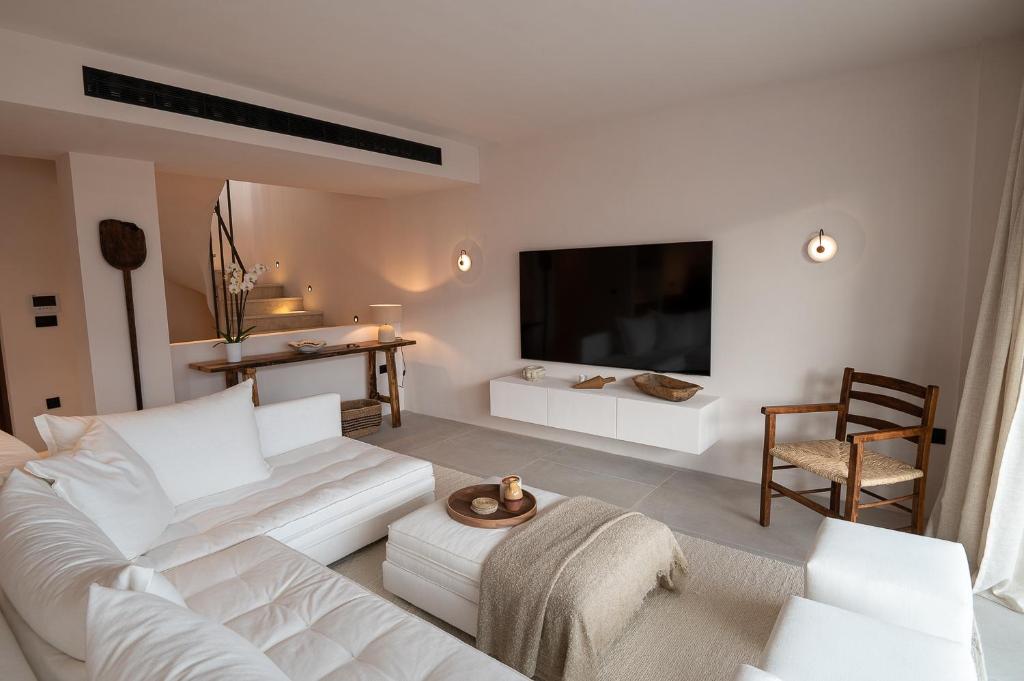a living room with a white couch and a flat screen tv at OVILIO KALAMATA in Kalamata