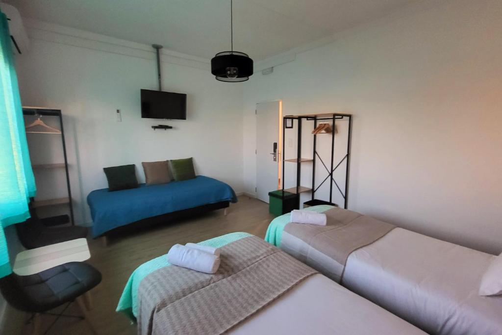 a living room with two beds and a couch at Casa Borges in Charneca