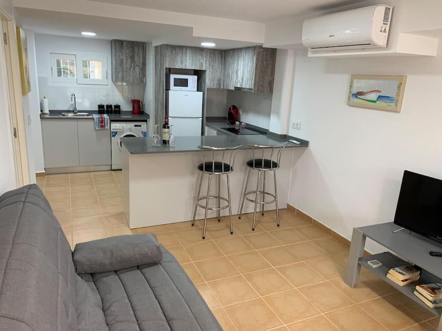 a living room with a kitchen with a counter top at Modern Apartment Near Beach in La Mata
