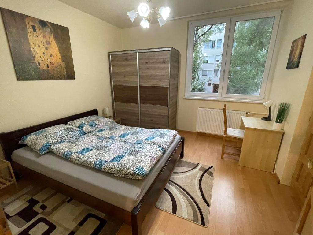 a bedroom with a bed and a window at Feels like home in green Zuglo in Budapest