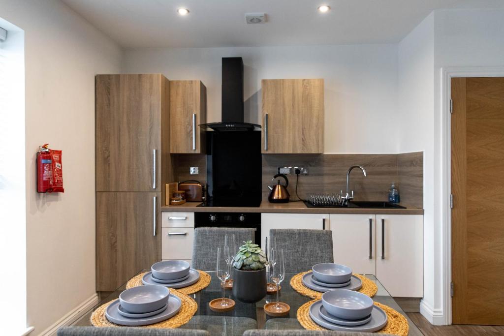 a kitchen with a table with dishes on it at Stylish Jewellery Quarter Apartment Sleeps 6 in Birmingham