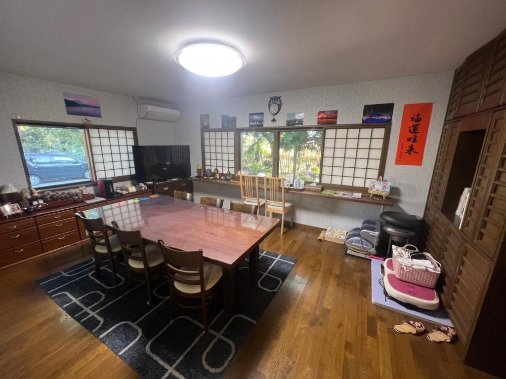 a dining room with a wooden table and chairs at Fukurou no Oyado - Vacation STAY 71286v in Fuefuki