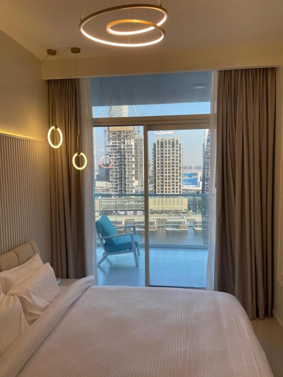 a bedroom with a bed and a view of a city at New Luxury Modern Canal View. in Dubai